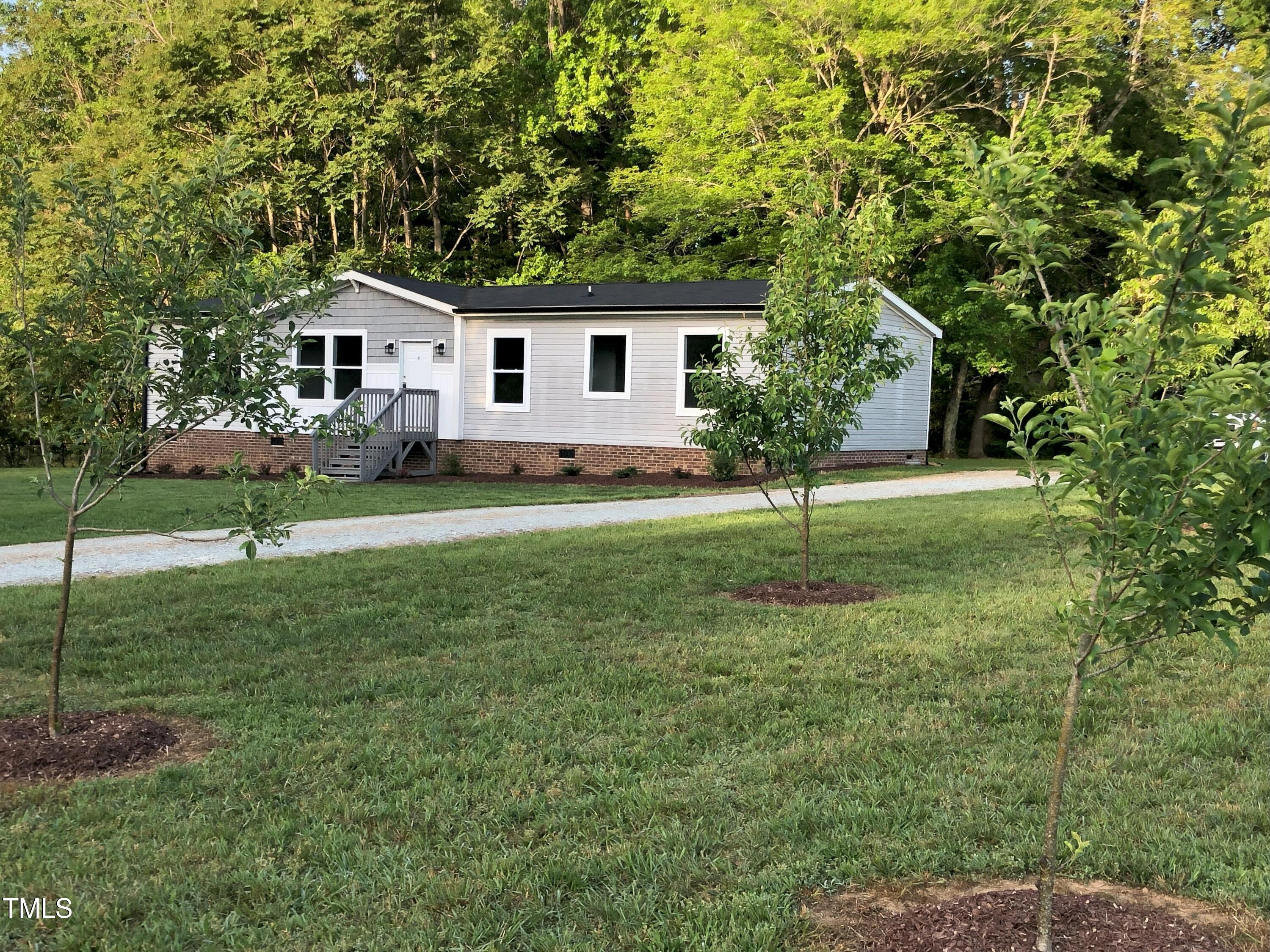 550 Saplin Branch Road Timberlake, NC 27583 - Photo 30 of 33 a view of a house with a backyard