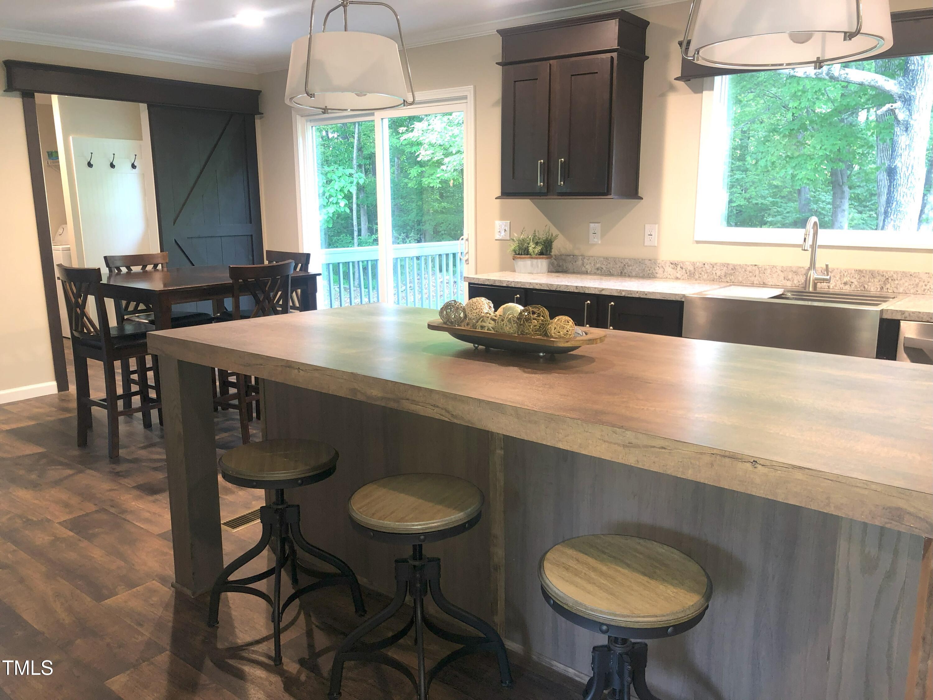 550 Saplin Branch Road Timberlake, NC 27583 - Photo 4 of 33 a kitchen with a sink a window and a wooden cabinets