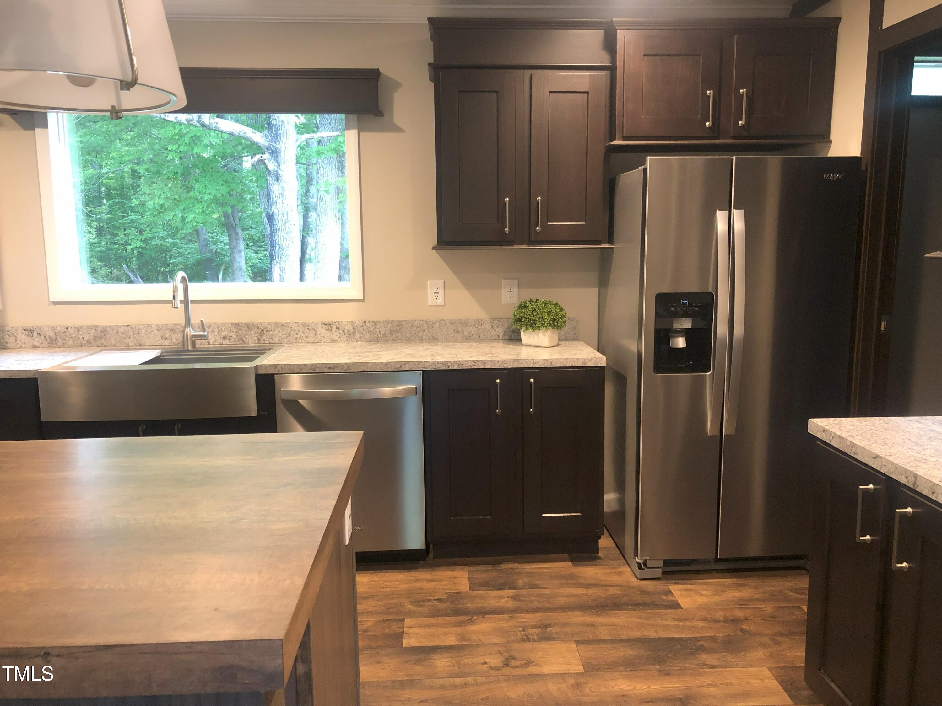 550 Saplin Branch Road Timberlake, NC 27583 - Photo 7 of 33 a kitchen with stainless steel appliances granite countertop a sink stove and refrigerator