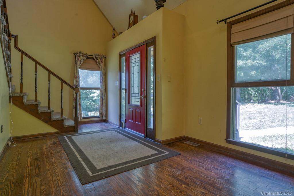 6074 Hunting Country Road Tryon, NC 28782 - Photo 22 of 34 a view of an empty room with wooden floor and a window