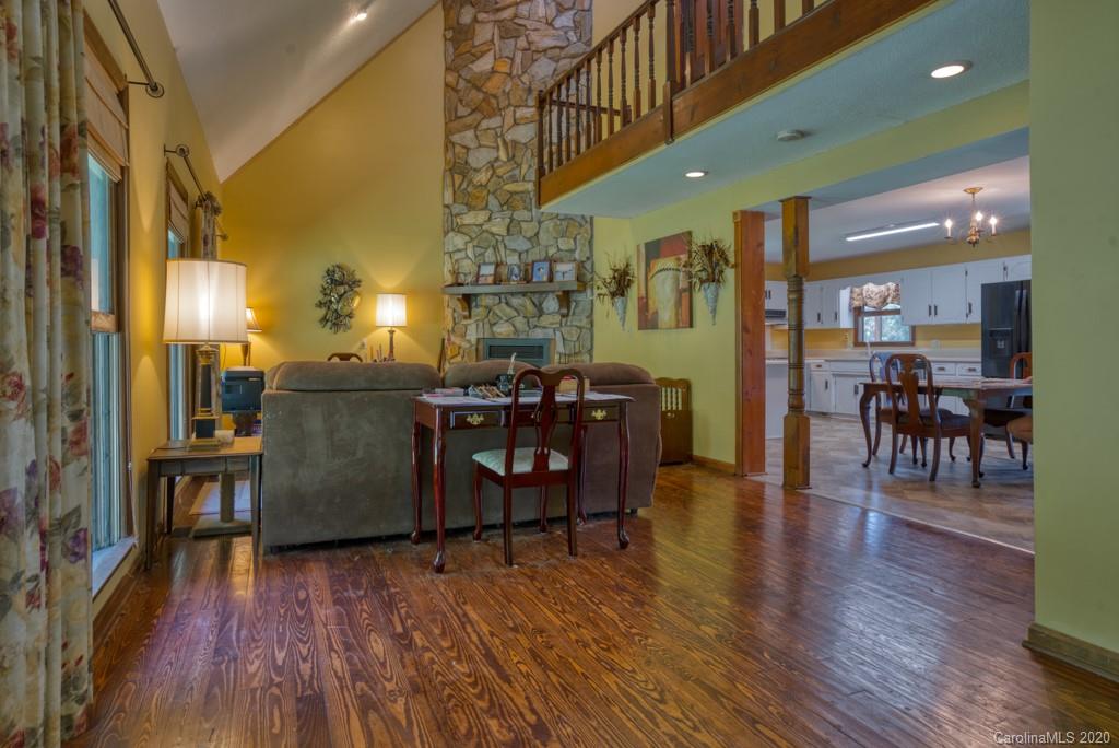 6074 Hunting Country Road Tryon, NC 28782 - Photo 23 of 34 a dining room with furniture a chandelier and wooden floor