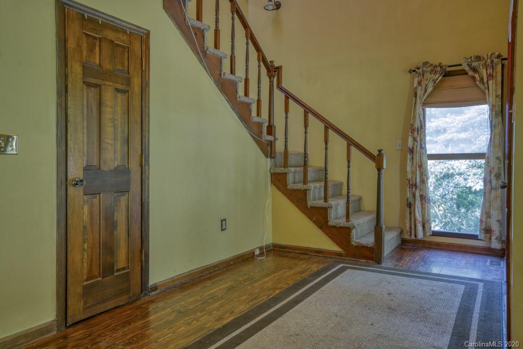 6074 Hunting Country Road Tryon, NC 28782 - Photo 33 of 34 a view of an entryway with wooden floor and door