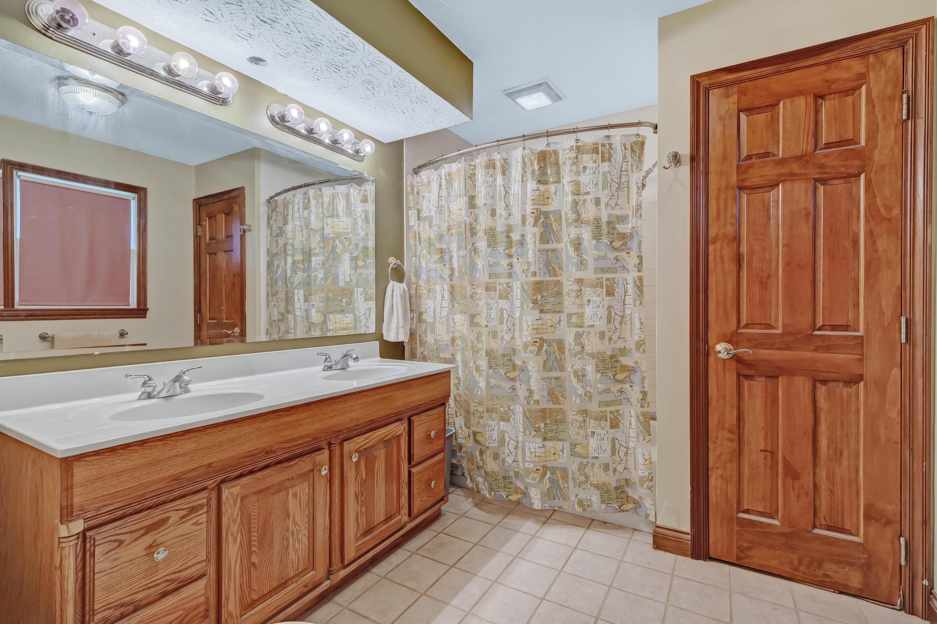 8558 Morris Road Hilliard, OH 43026 - Photo 13 of 74 • Ceramic tile flooring • Sage painted walls • Ceiling light • Lighted ceiling exhaust • Tub/shower combination with ceramic tile surround • Linen closet • Enclosed vanity with double bowl, cultured marbled sinktop • (2) Four-bulb wall lights