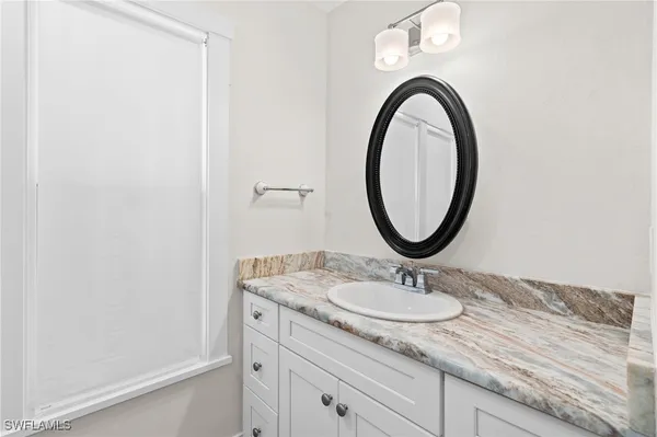 a bathroom with a shower and a sink