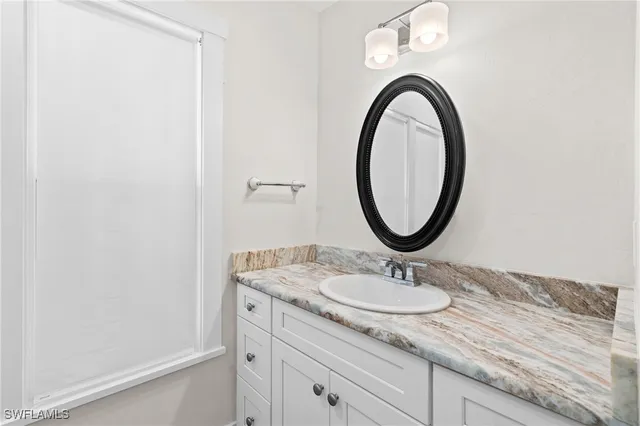 a bathroom with a shower and a sink