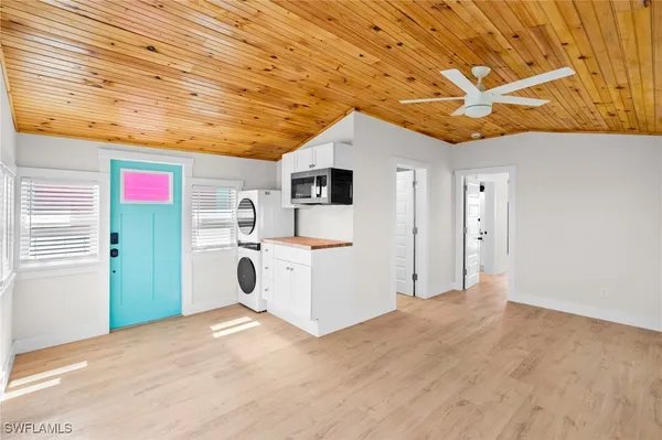 a utility room with dryer washer and a view of kitchen