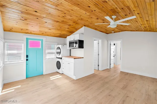 a utility room with dryer washer and a view of kitchen
