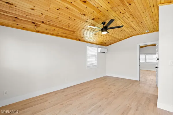 a large kitchen with stainless steel appliances granite countertop a stove a sink dishwasher a microwave oven with cabinets and wooden floor