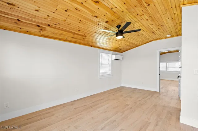 a large kitchen with stainless steel appliances granite countertop a stove a sink dishwasher a microwave oven with cabinets and wooden floor