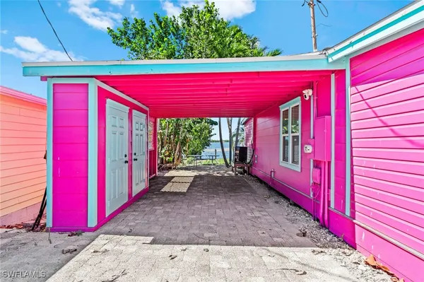 a view of a house with a bed and wooden fence
