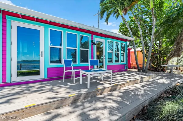 a view of a house with a swimming pool and sitting area