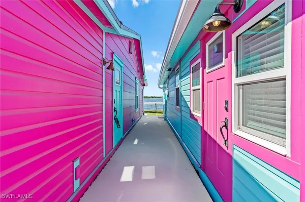 a view of a patio with table and chairs and floor to ceiling window