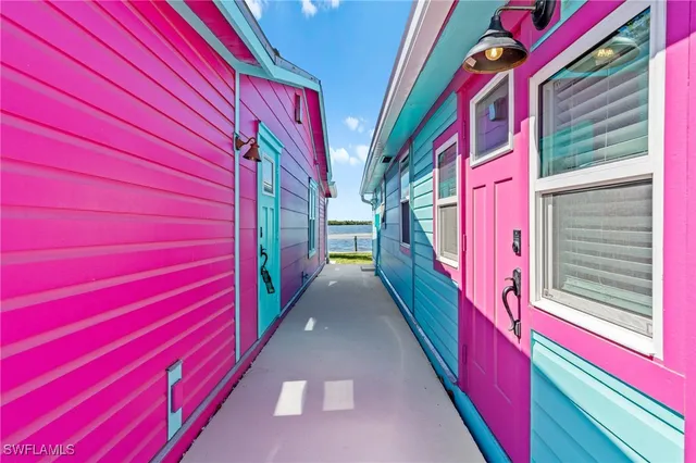a view of a patio with table and chairs and floor to ceiling window