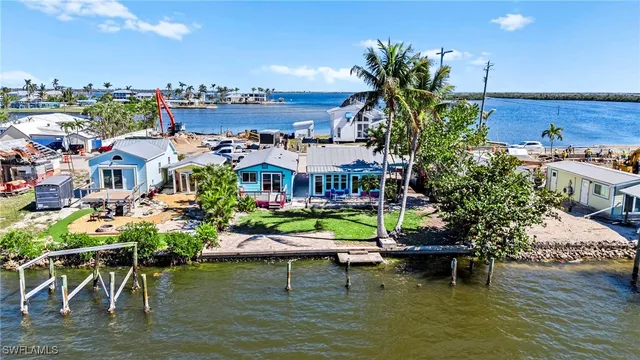 a view of a lake with lawn chairs
