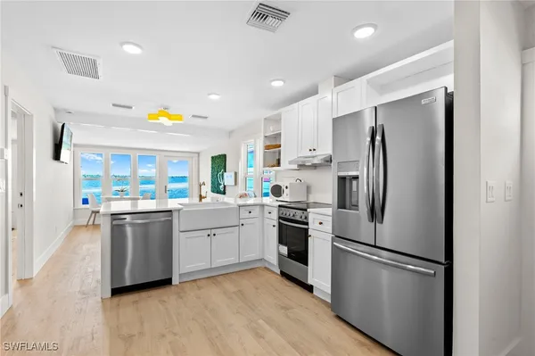 a kitchen with a refrigerator and a sink