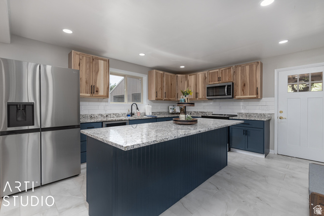 2807 North Ogden Canyon Road Eden, UT 84310 - Photo 8 of 72 Kitchen featuring a spacious island with beadboard paneling, light-toned countertops, two-tone cabinetry, stainless steel appliances, and white tile flooring