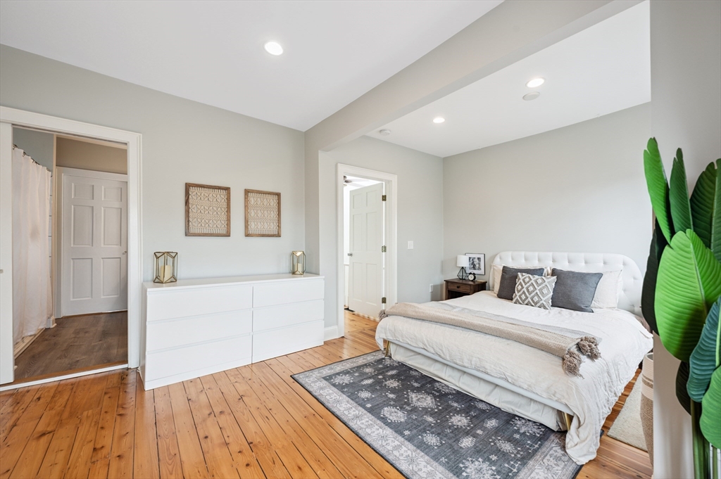 173 H Street, Unit 2 Boston, MA 02127 - Photo 13 of 26 a bedroom with a bed and a potted plant