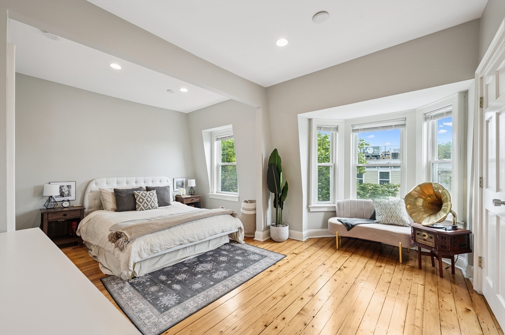 173 H Street, Unit 2 Boston, MA 02127 - Photo 15 of 26 a bedroom with a bed and large wooden floor