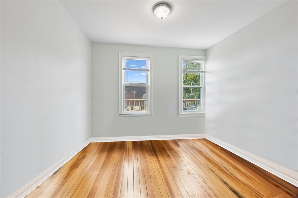 173 H Street, Unit 2 Boston, MA 02127 - Photo 19 of 26 an empty room with wooden floor and windows