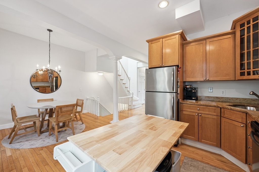 173 H Street, Unit 2 Boston, MA 02127 - Photo 7 of 26 a kitchen with stainless steel appliances granite countertop a dining table chairs sink and cabinets