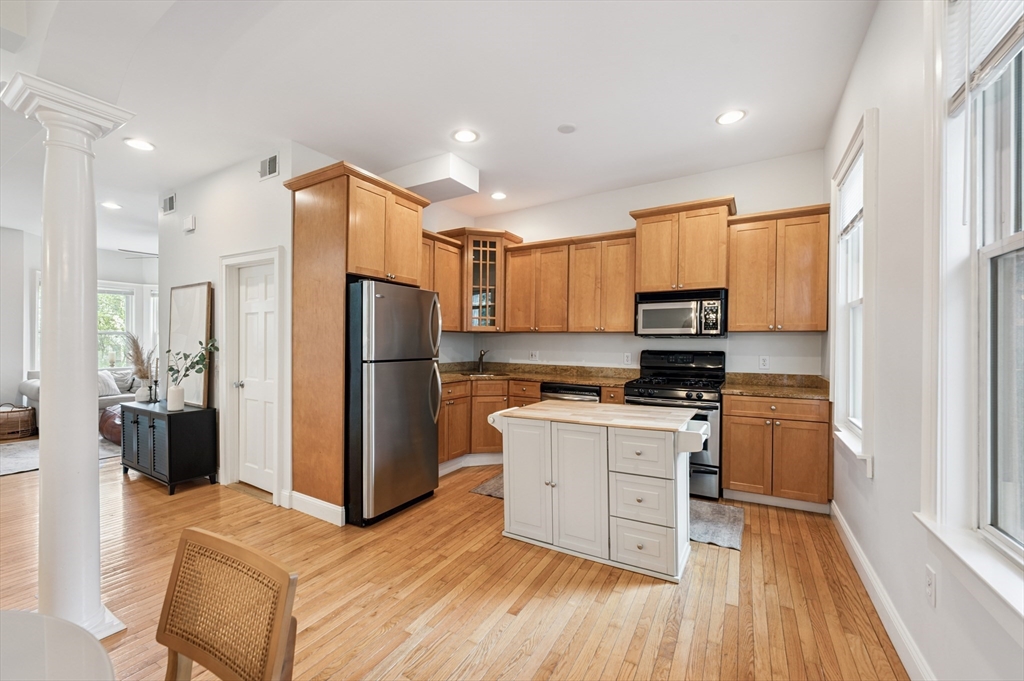 173 H Street, Unit 2 Boston, MA 02127 - Photo 8 of 26 a kitchen with a refrigerator a stove top oven a sink and a refrigerator