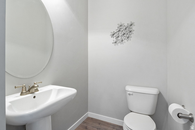 5155 East Rio Grande Way Eagle Mountain, UT 84005 - Photo 13 of 40 Half bath featuring baseboards and dark wood-type flooring