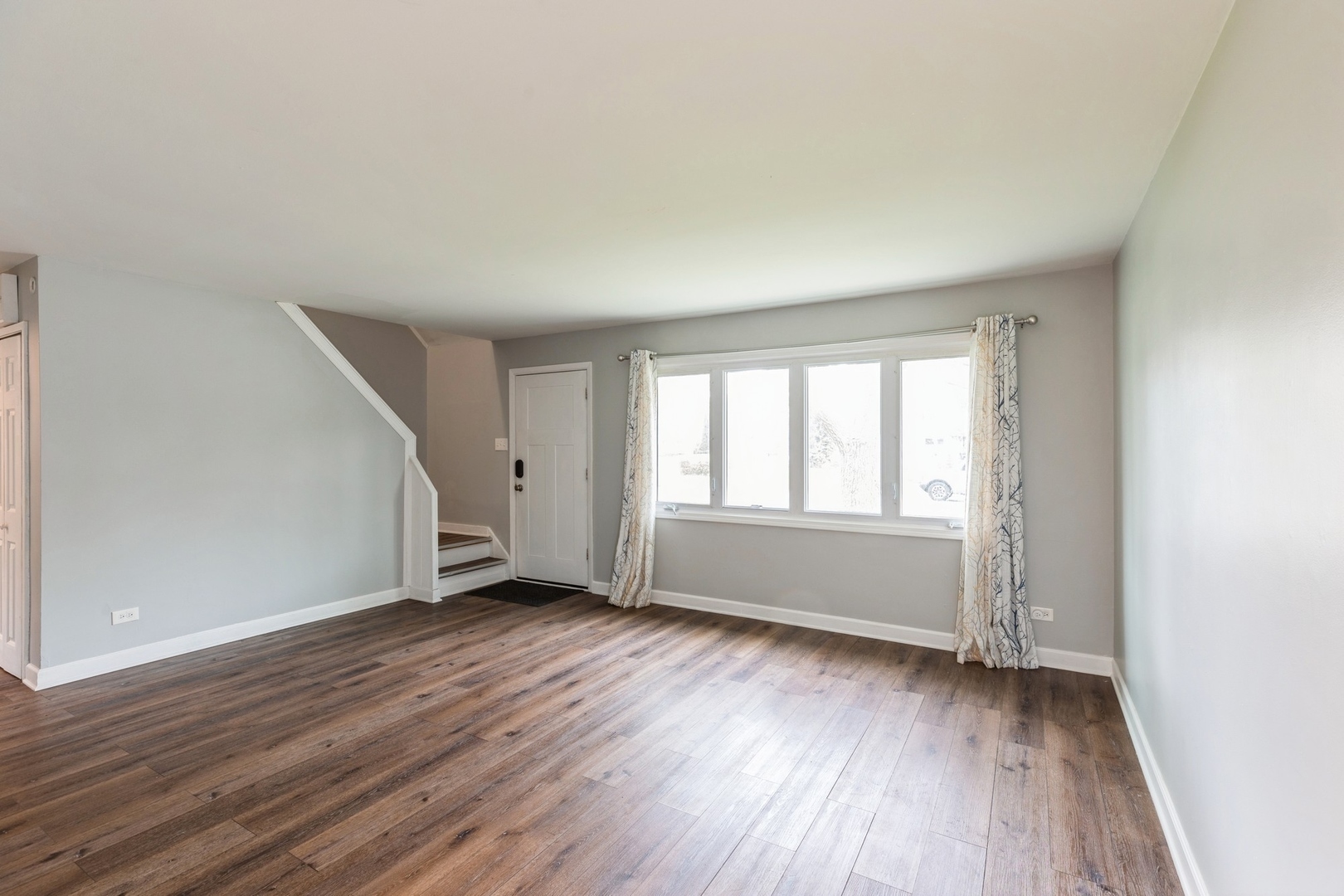 433 Wildwood Drive Park Forest, IL 60466 - Photo 2 of 13 an empty room with wooden floor and windows