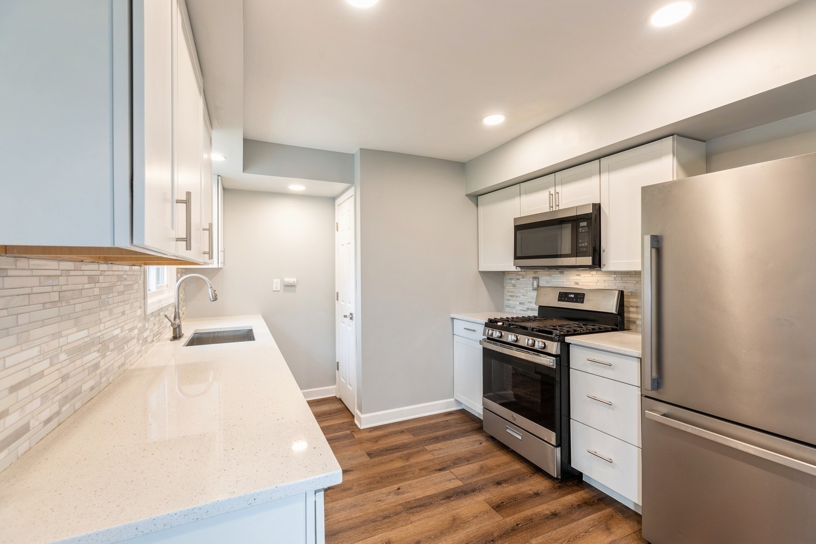 433 Wildwood Drive Park Forest, IL 60466 - Photo 4 of 13 a kitchen with a sink a stove and refrigerator