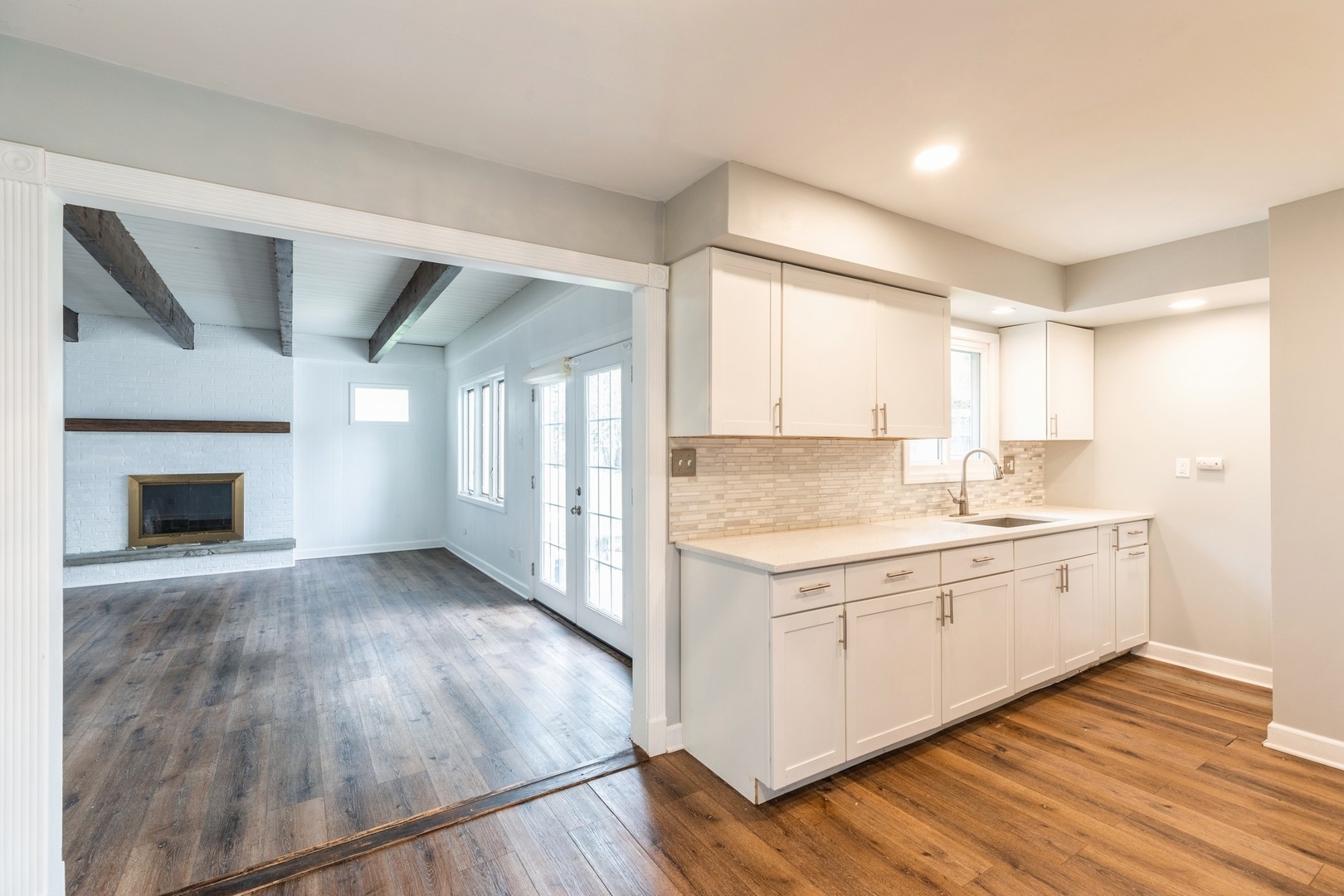 433 Wildwood Drive Park Forest, IL 60466 - Photo 5 of 13 a view of a kitchen with a sink wooden cabinets and a window