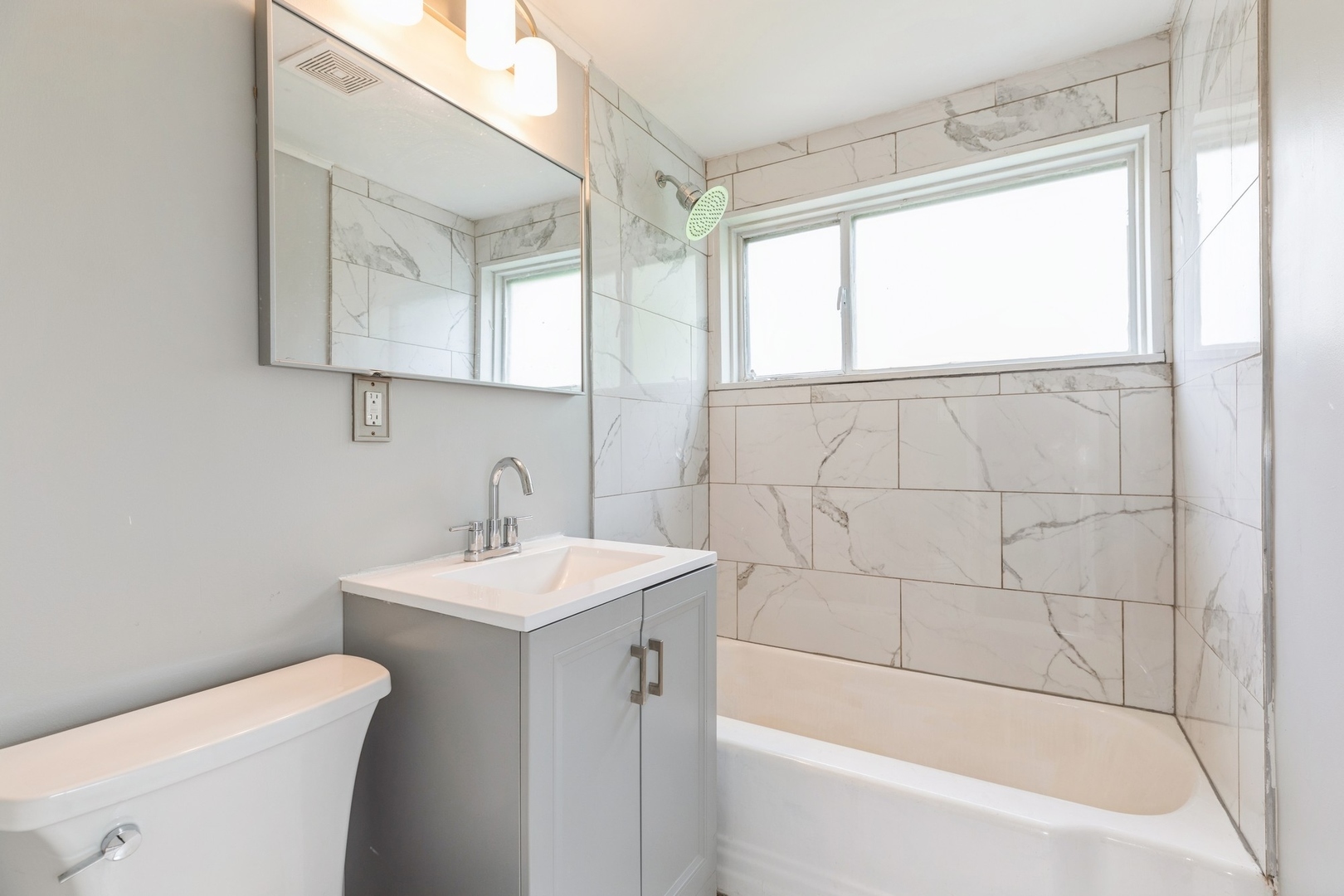 433 Wildwood Drive Park Forest, IL 60466 - Photo 7 of 13 a bathroom with a sink a toilet and shower