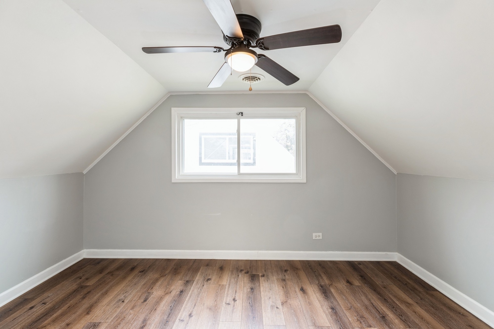 433 Wildwood Drive Park Forest, IL 60466 - Photo 9 of 13 an empty room with wooden floor chandelier fan and windows