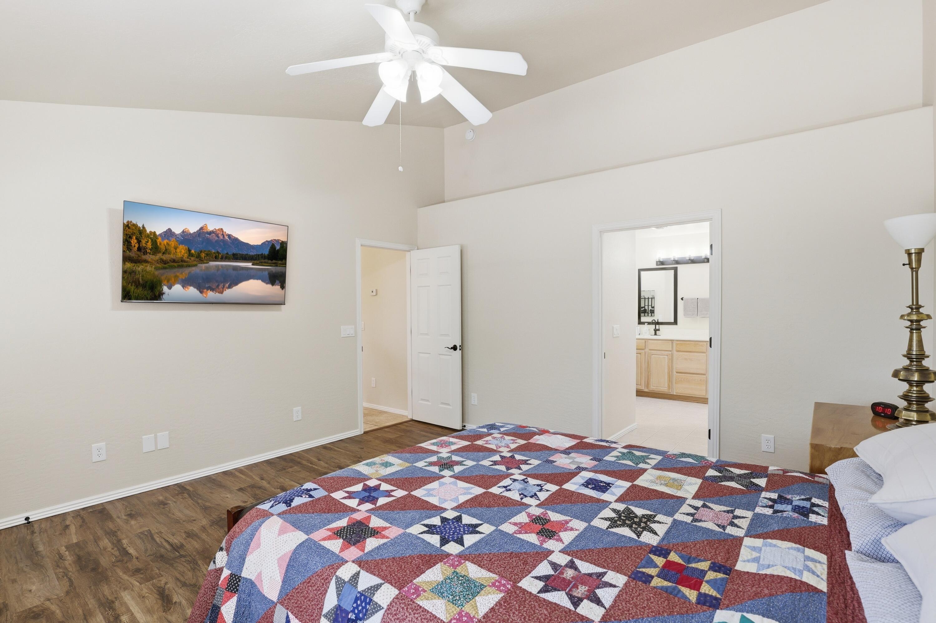 910 West Wagon Trail Payson, AZ 85541 - Photo 14 of 35 a bedroom with a large bed and a chandelier