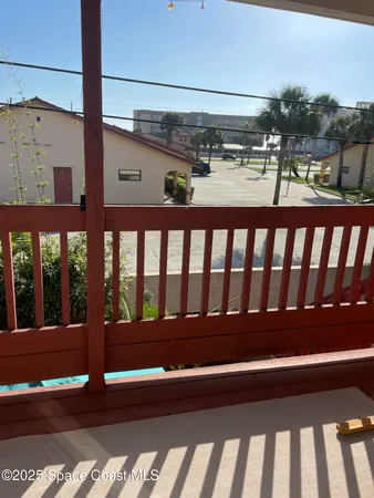 a view of a patio with a table and chairs and potted plants