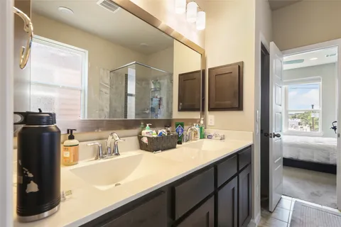 a bathroom with a sink a toilet and a mirror