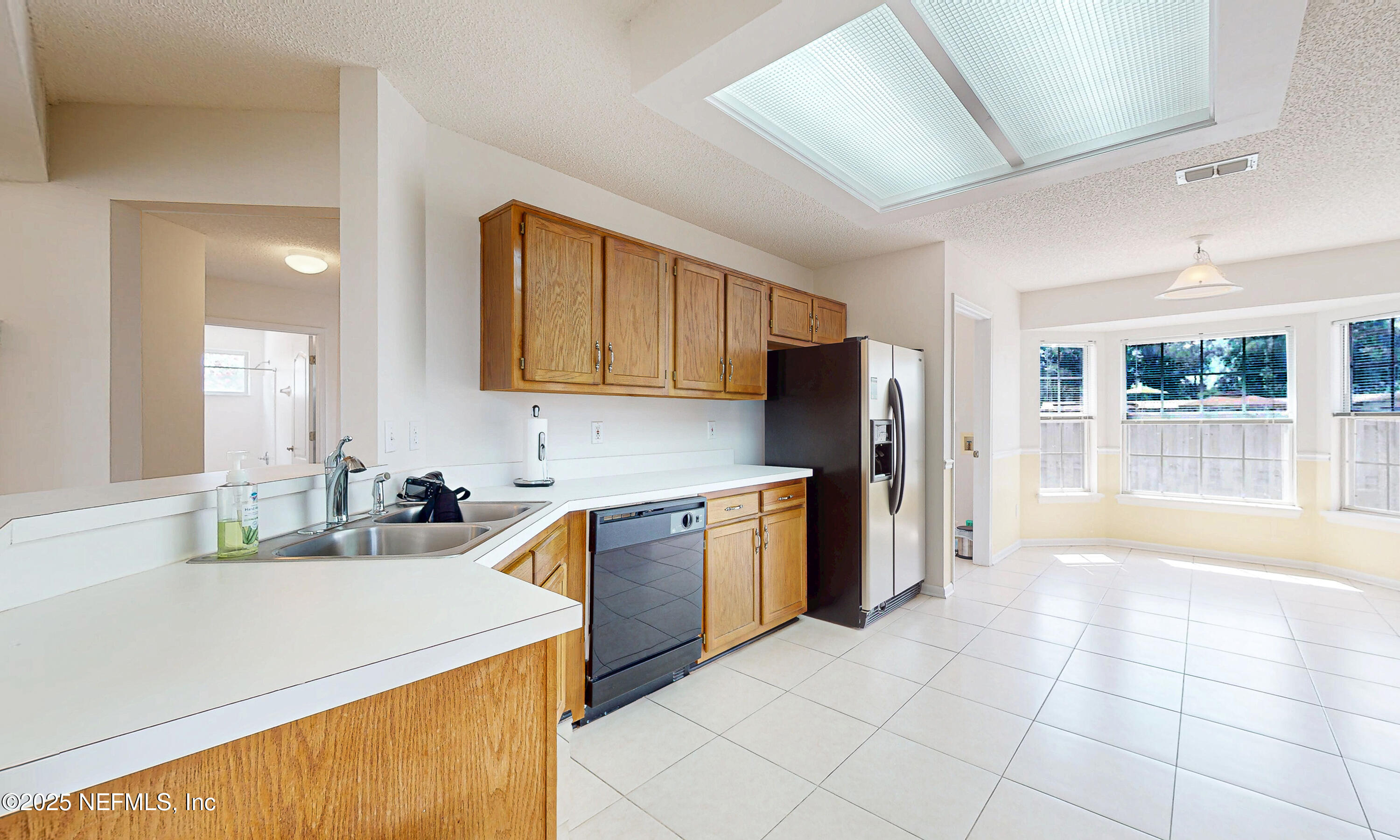 2031 Canyon Rim Place Middleburg, FL 32068 - Photo 10 of 38 a kitchen with a sink a stove and refrigerator