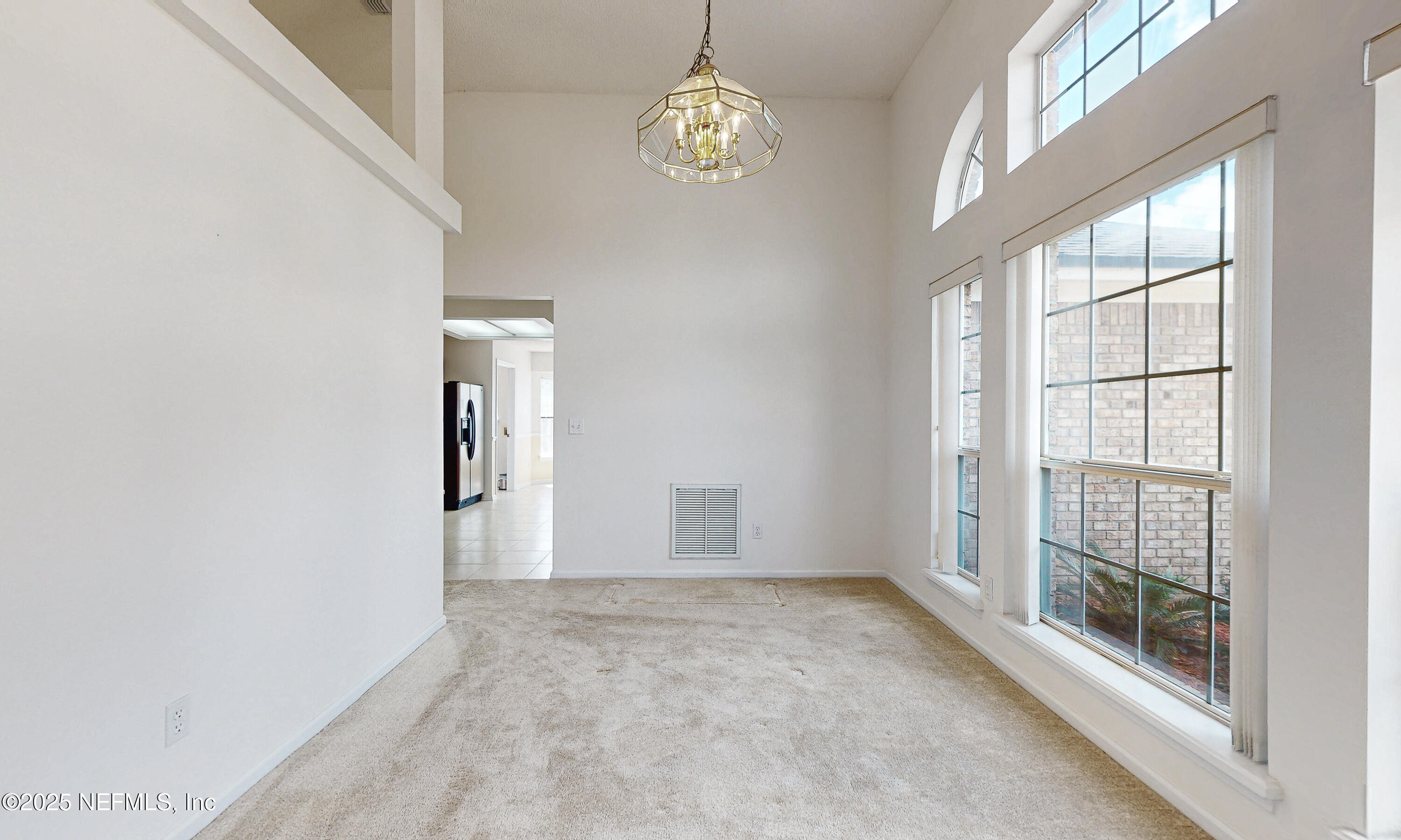 2031 Canyon Rim Place Middleburg, FL 32068 - Photo 13 of 38 an empty room with windows and entrance