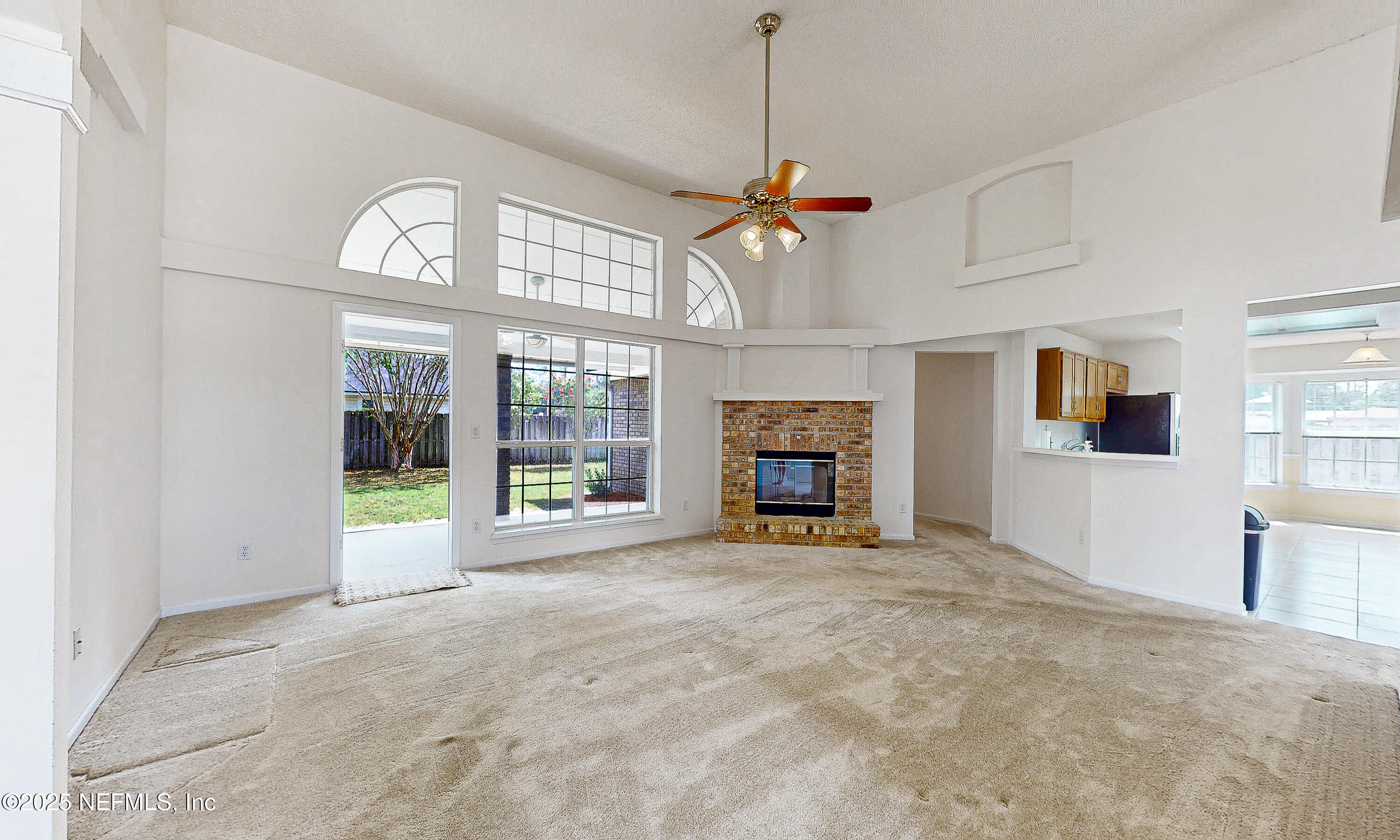 2031 Canyon Rim Place Middleburg, FL 32068 - Photo 32 of 38 a view of an empty room with a fireplace and a window