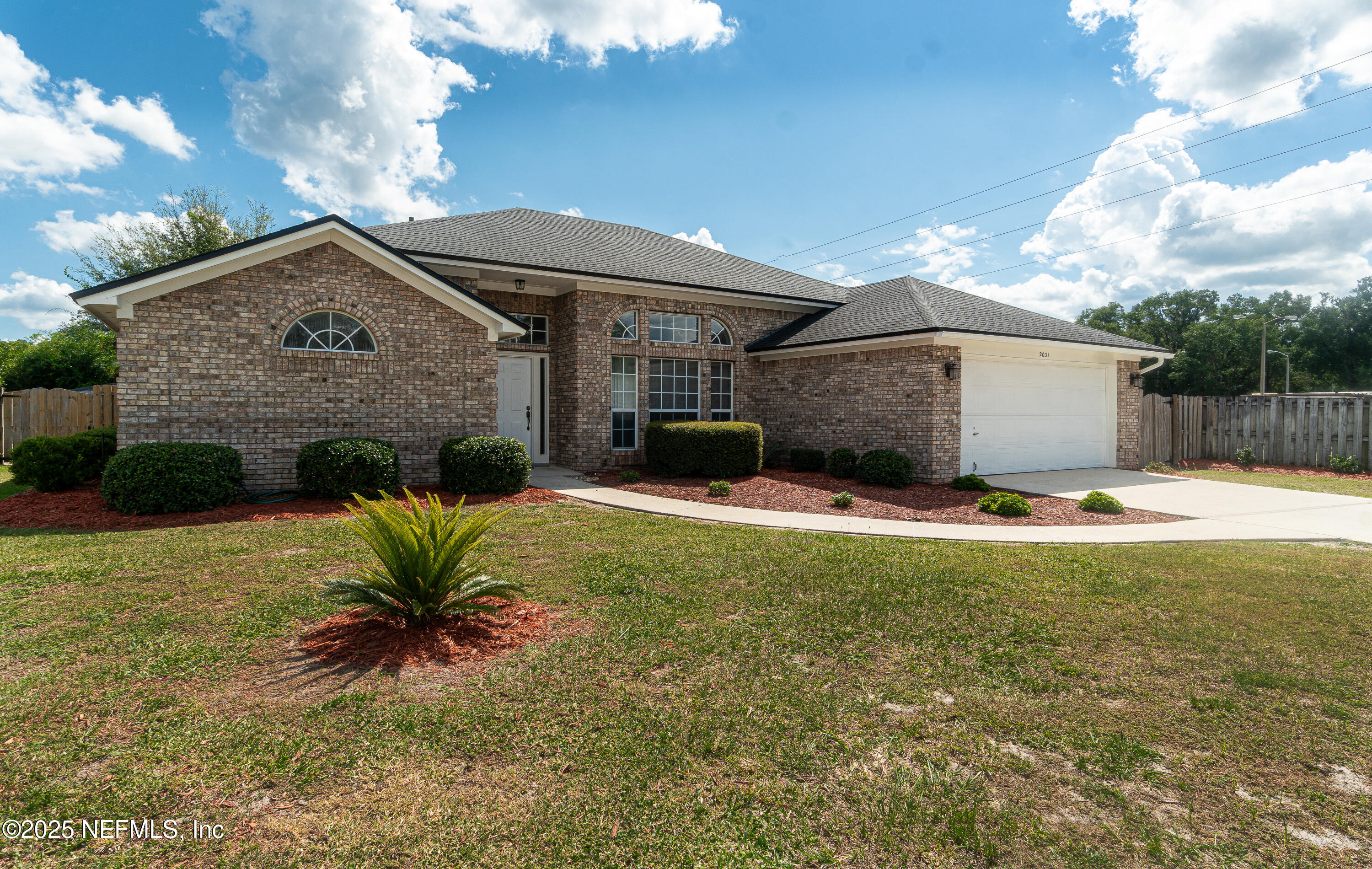 2031 Canyon Rim Place Middleburg, FL 32068 - Photo 37 of 38 a front view of a house with a yard and potted plants