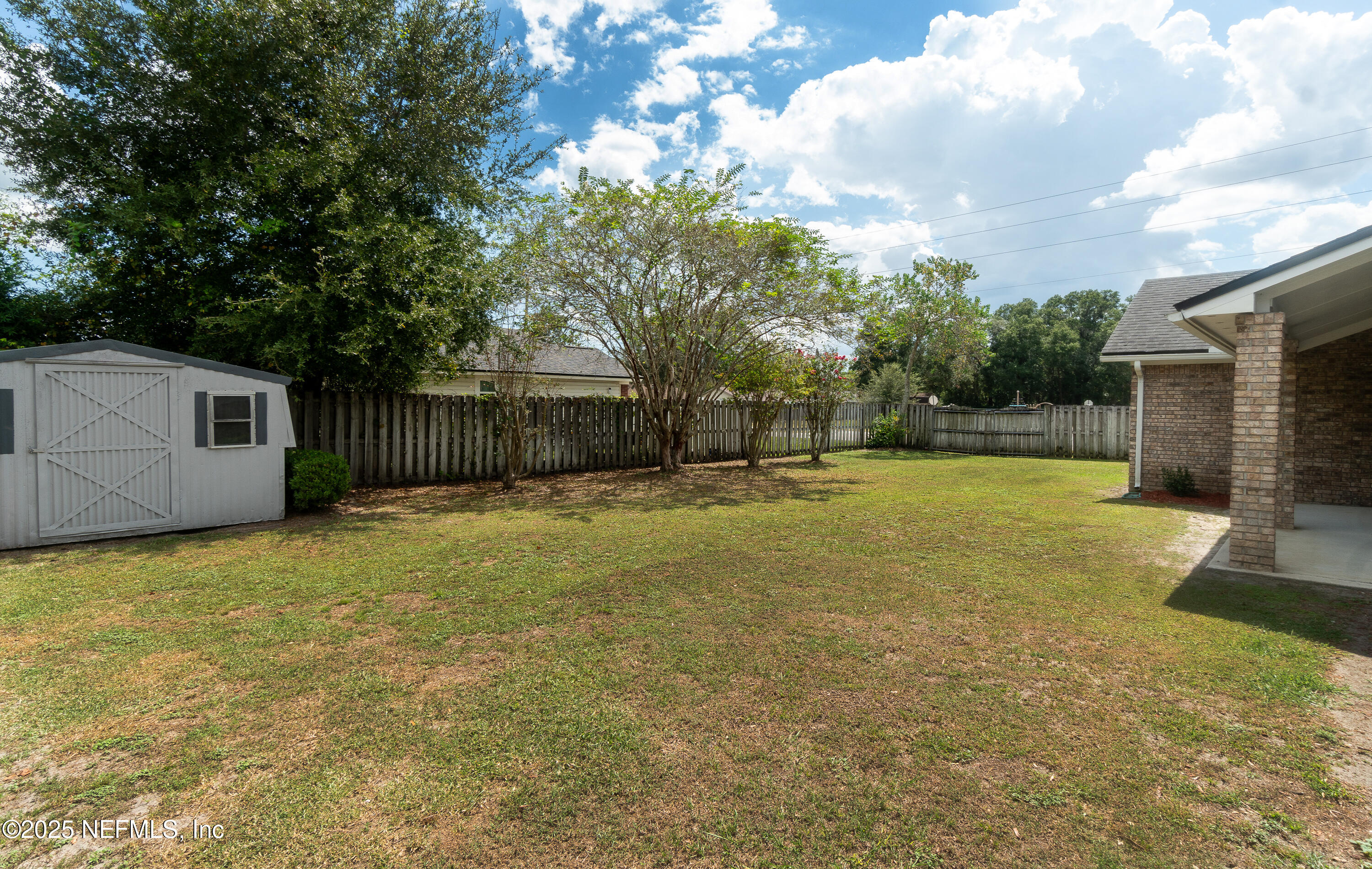 2031 Canyon Rim Place Middleburg, FL 32068 - Photo 4 of 38 a backyard of a house with table and chairs