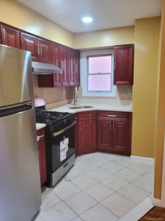 a kitchen with stainless steel appliances granite countertop a stove a refrigerator and a sink