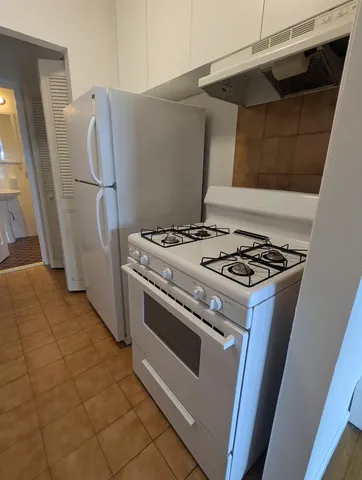 a white stove top oven sitting inside of a house