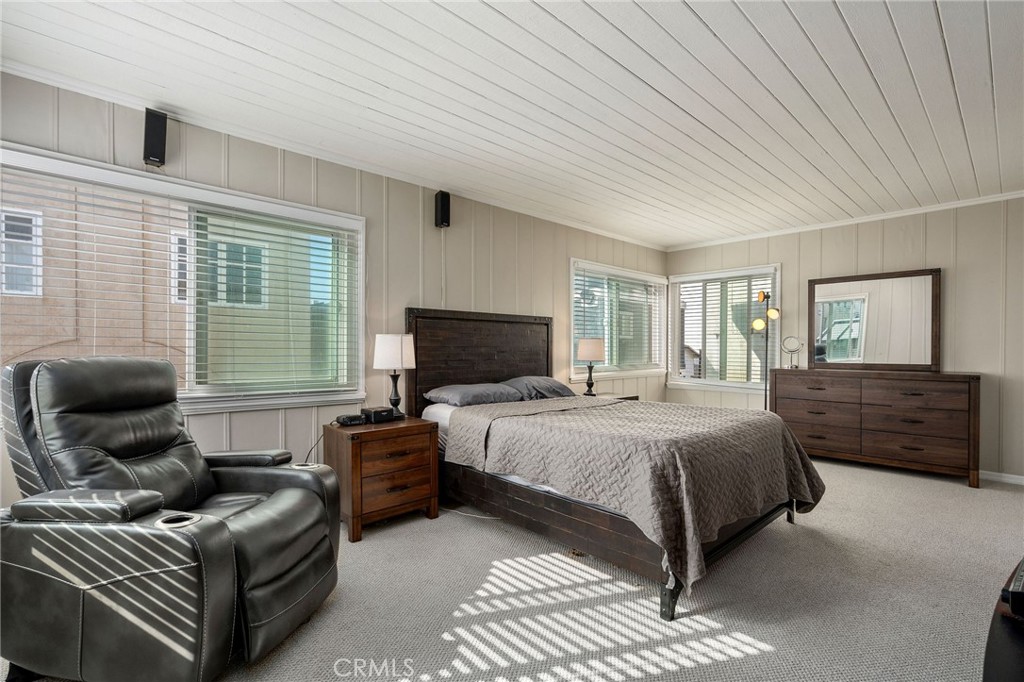 24 B Surfside Avenue Surfside, CA 90743 - Photo 11 of 22 a bedroom with a bed and wooden floor