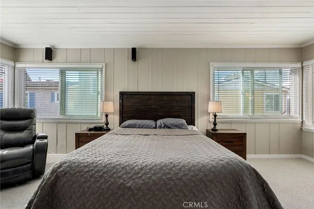 a bedroom with a large bed and a window