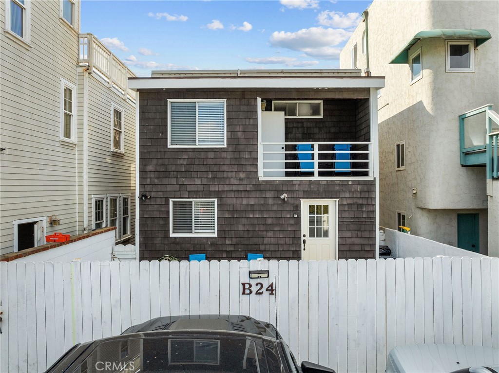 24 B Surfside Avenue Surfside, CA 90743 - Photo 18 of 22 a front view of a house with large windows