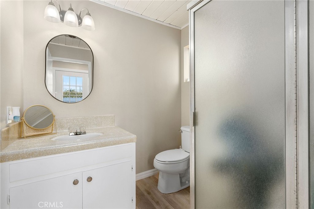 24 B Surfside Avenue Surfside, CA 90743 - Photo 10 of 22 a bathroom with a toilet sink and mirror
