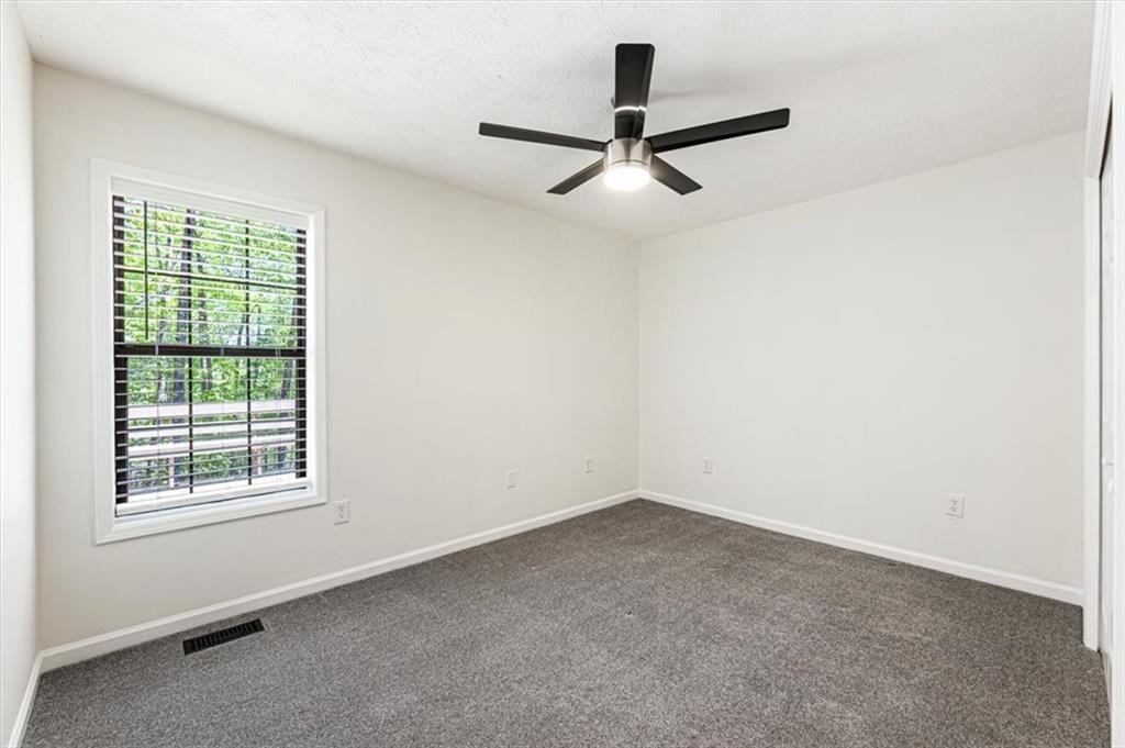 190 Red Coat Pass Jasper, GA 30143 - Photo 33 of 43 an empty room with a window and a ceiling fan
