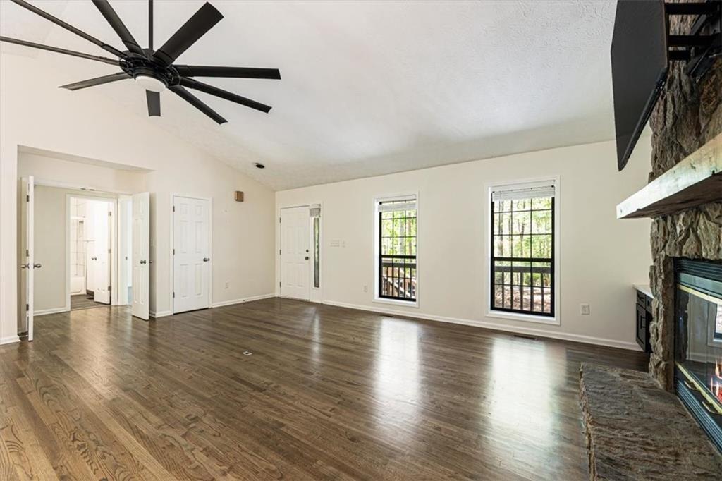 190 Red Coat Pass Jasper, GA 30143 - Photo 5 of 43 an empty room with wooden floor fan and windows