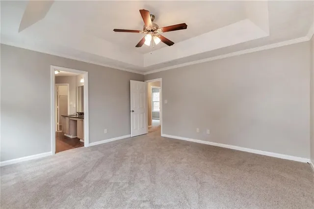 a view of an empty room and a ceiling fan