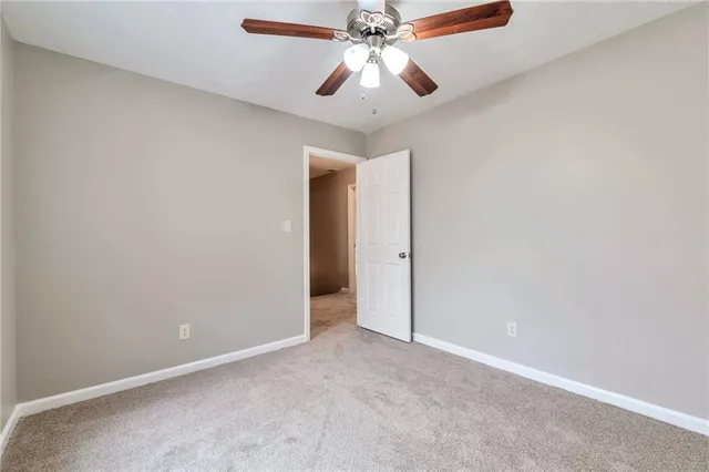 an empty room with a fan and a fan