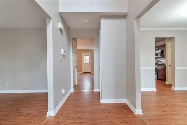 a view of a hallway with wooden floor